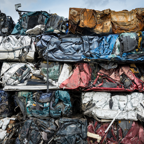 A pile of scrap vehicles which have been compressed for recycling.